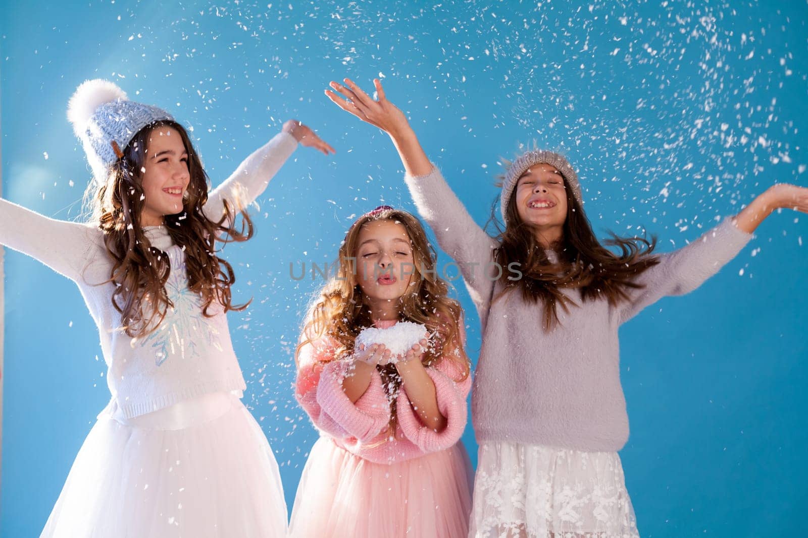 Three girls school girlfriends in winter snow cold hats by Simakov