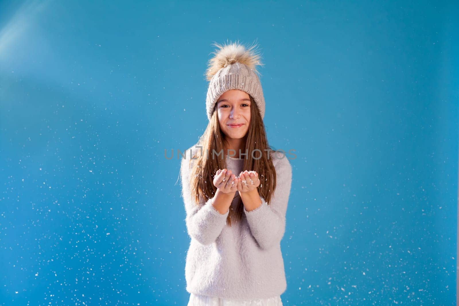 portrait of a fashionable girl in a winter snow cap by Simakov