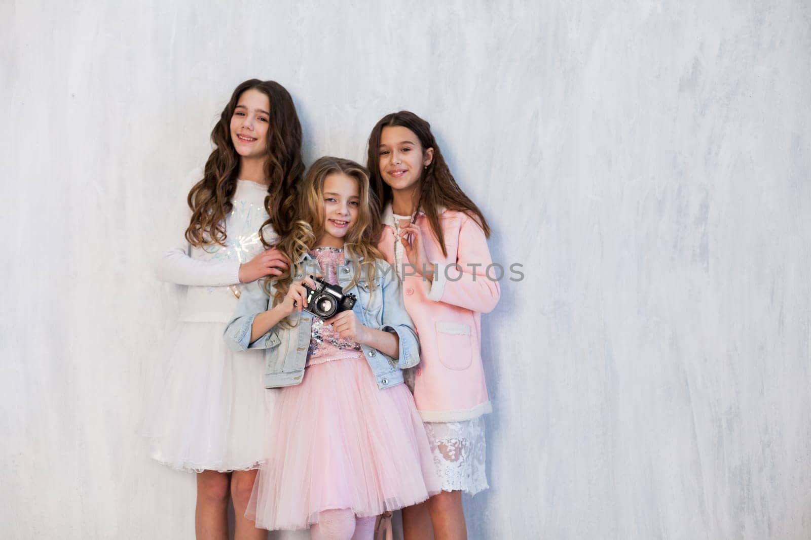 three fashionable girls school girlfriends in white pink dresses by Simakov