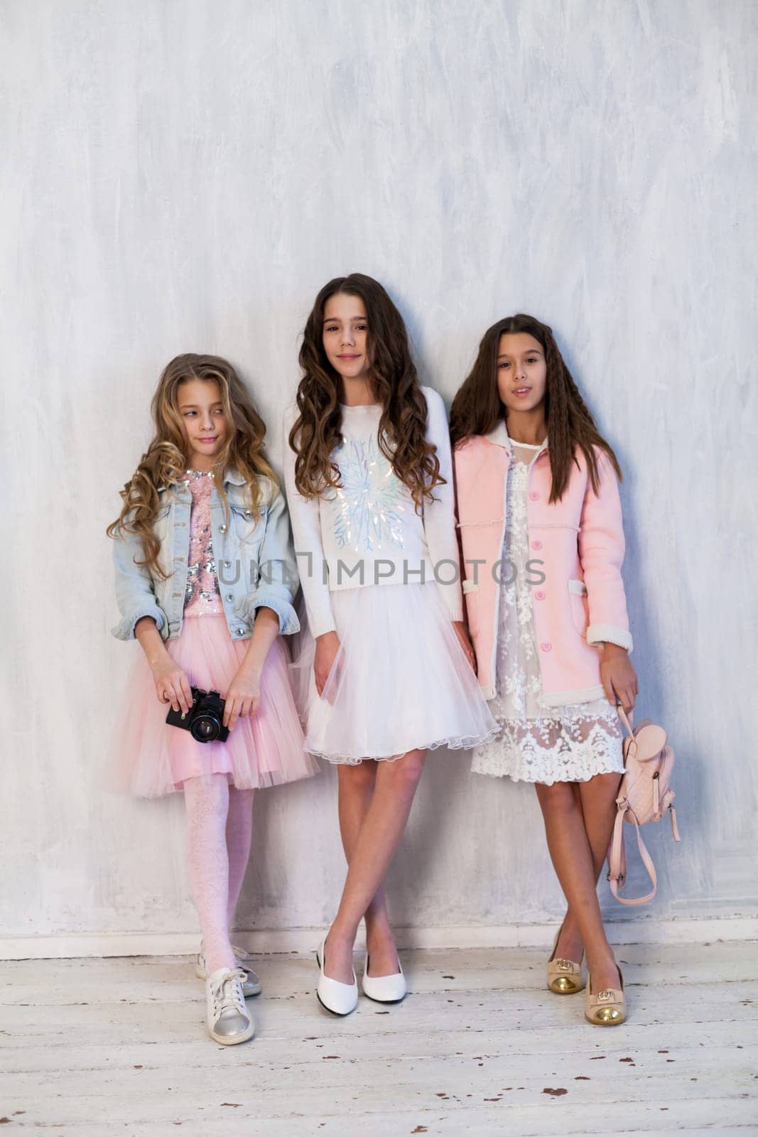 three fashionable girls school girlfriends in white pink dresses by Simakov