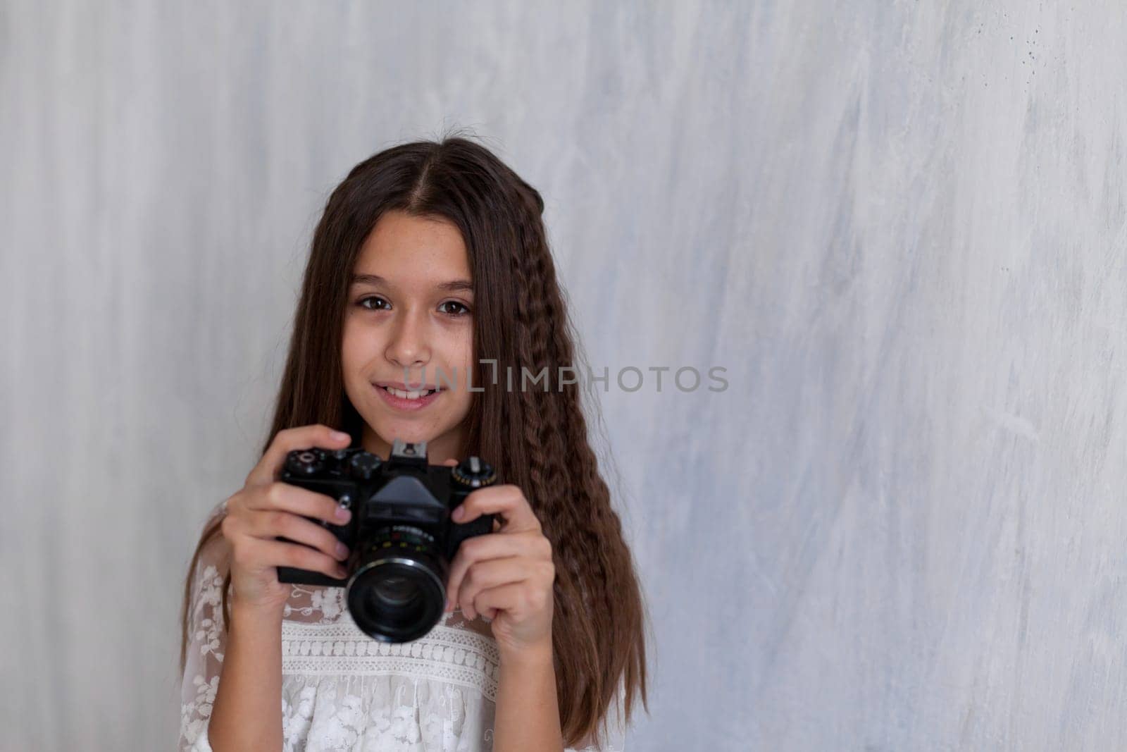 Portrait of a photographer girl with an old camera