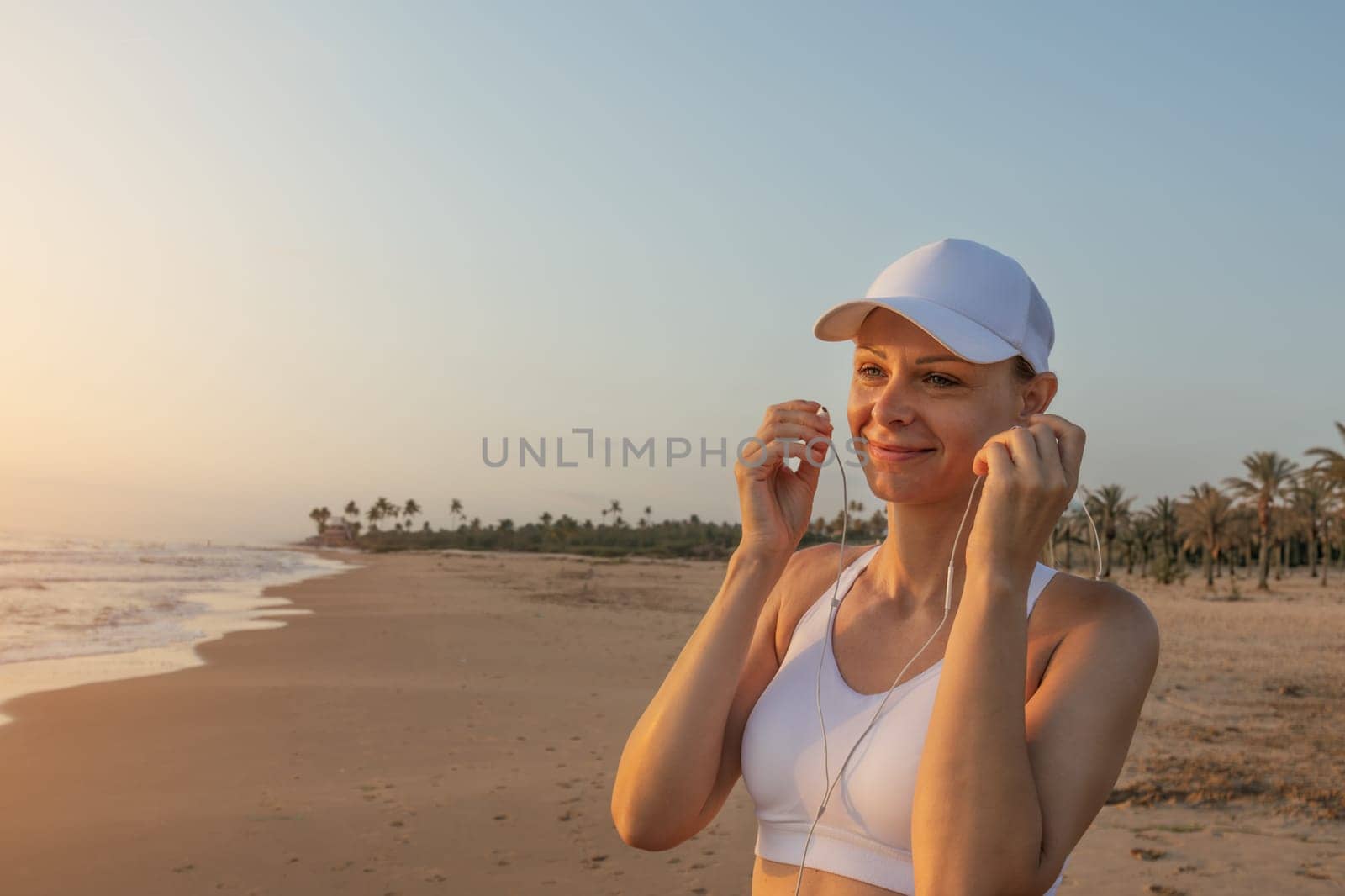 A girl of European appearance in a white cap stands against the background of the sea wearing headphones, there is a place for an inscription. Generated using AI High quality photo