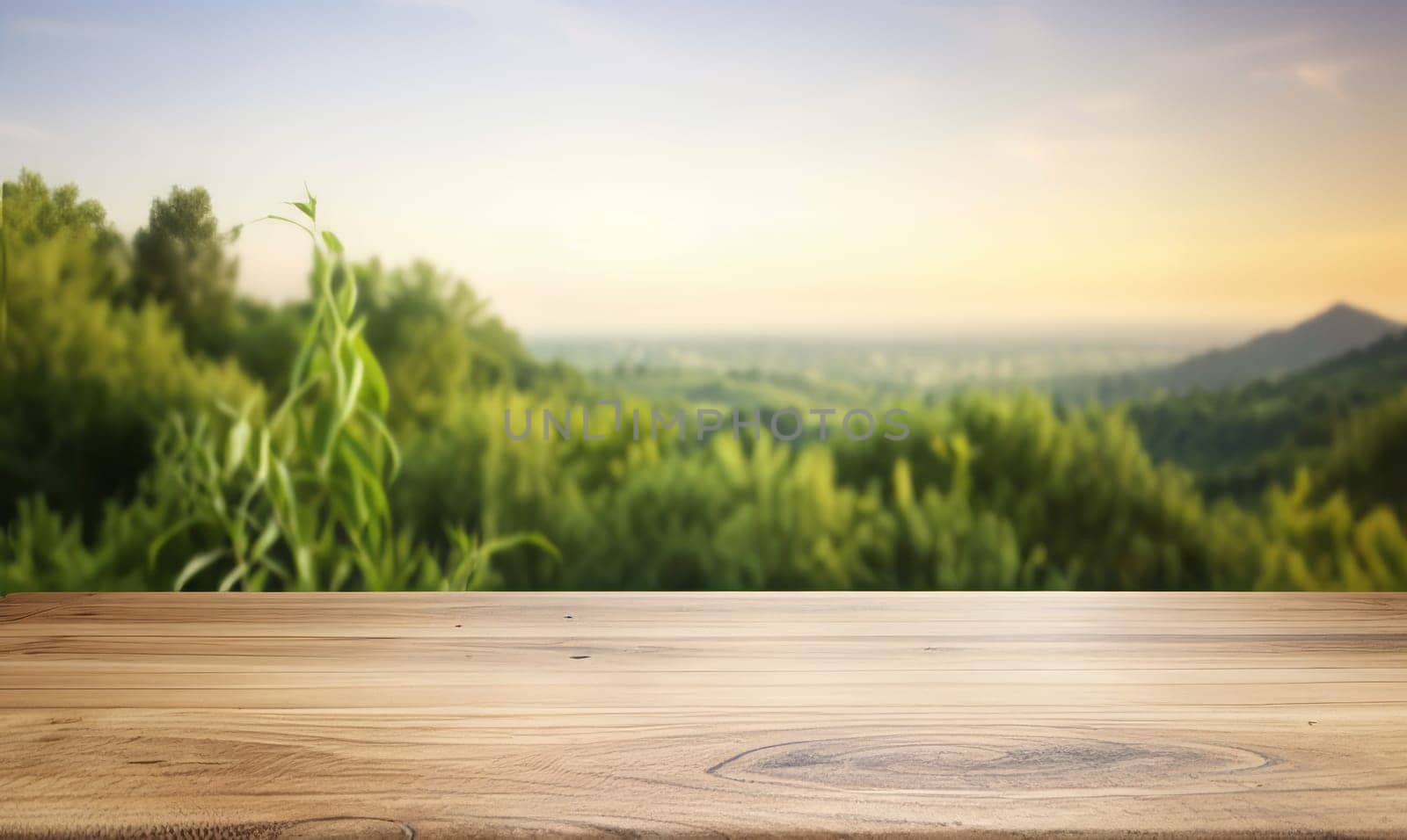 An empty wooden table top against the background of tropical mountains and trees at sunset