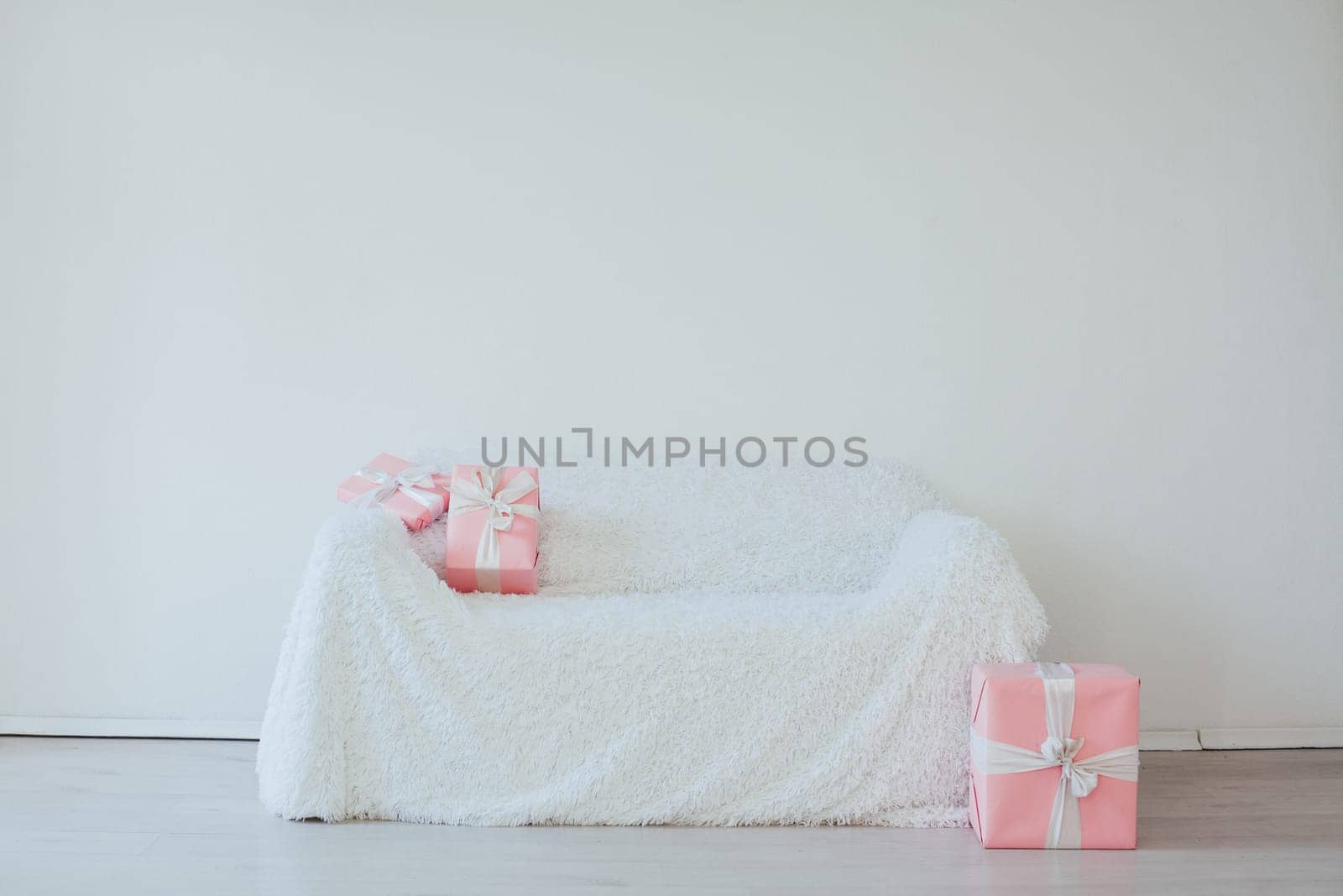 white sofa with gifts for birthday party Christmas by Simakov