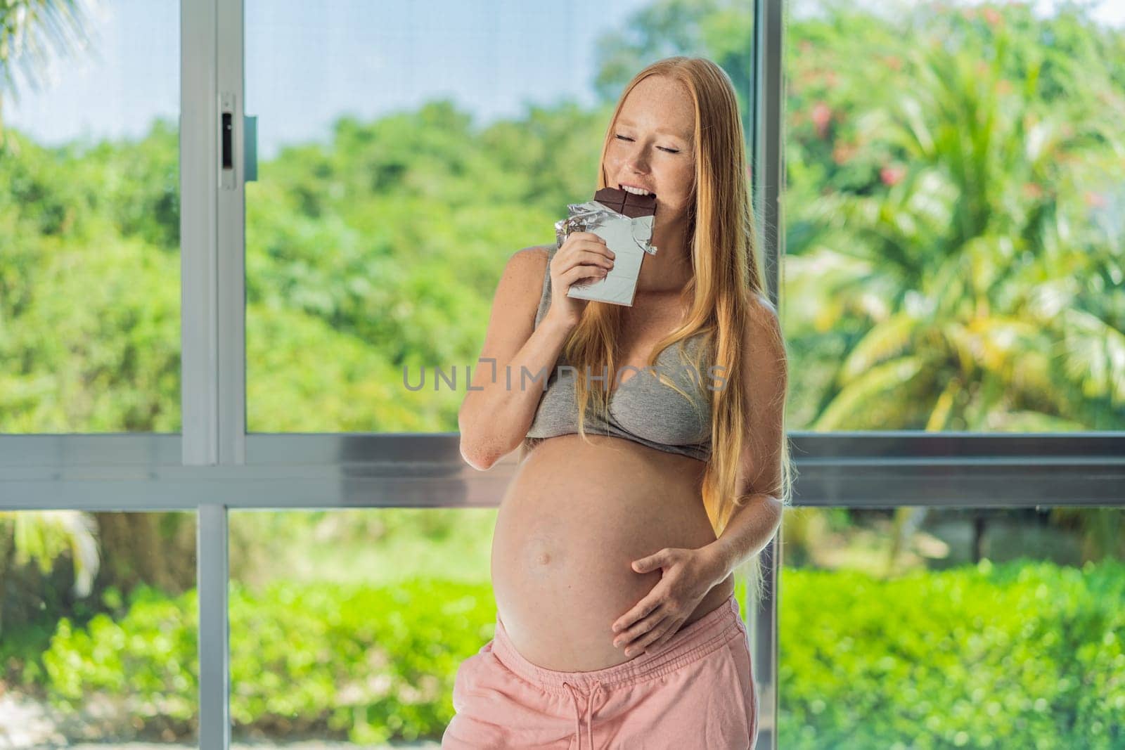 Capturing a pregnant woman enjoying chocolate, exploring the sweet indulgence during pregnancy, highlighting the delightful moments and potential effects of chocolate by galitskaya