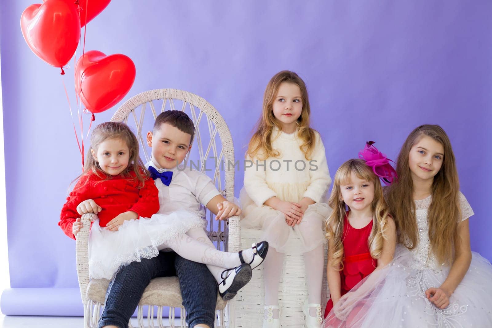 Kids boy and girls sit together at party