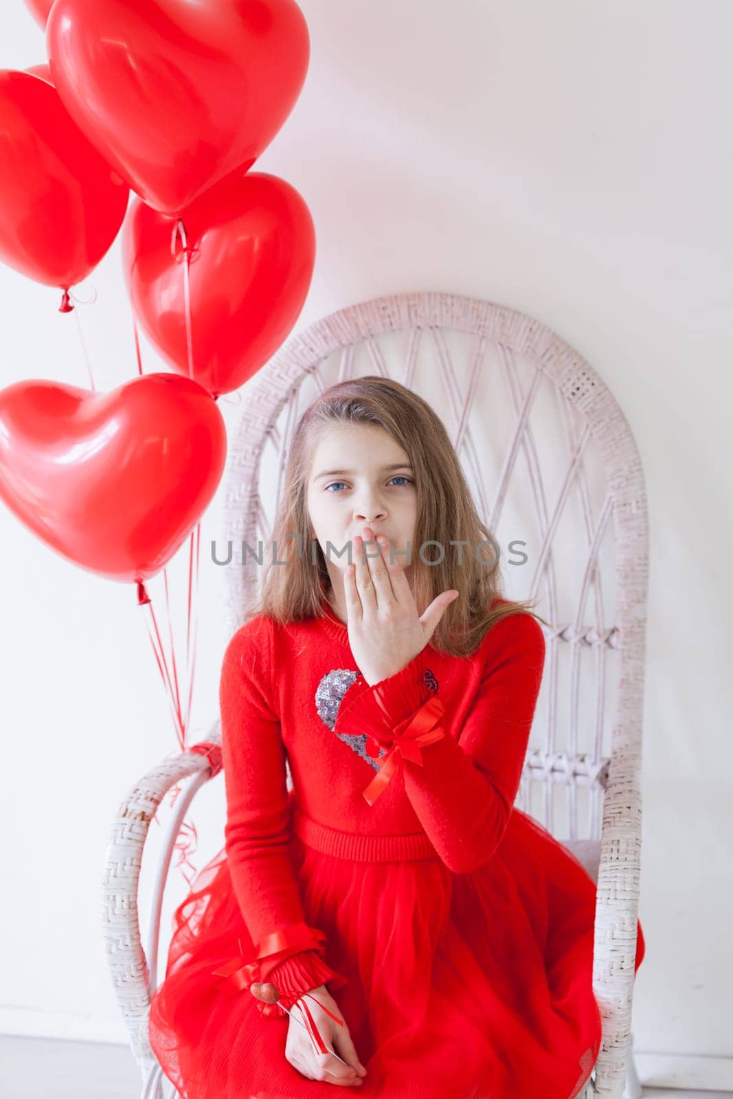 Little girl with red balloons on Valentine's Day by Simakov