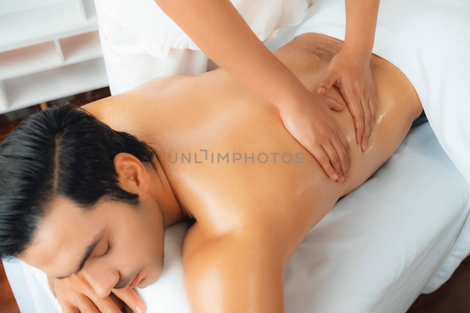 Caucasian man customer enjoying relaxing anti-stress massage. Quiescent by biancoblue