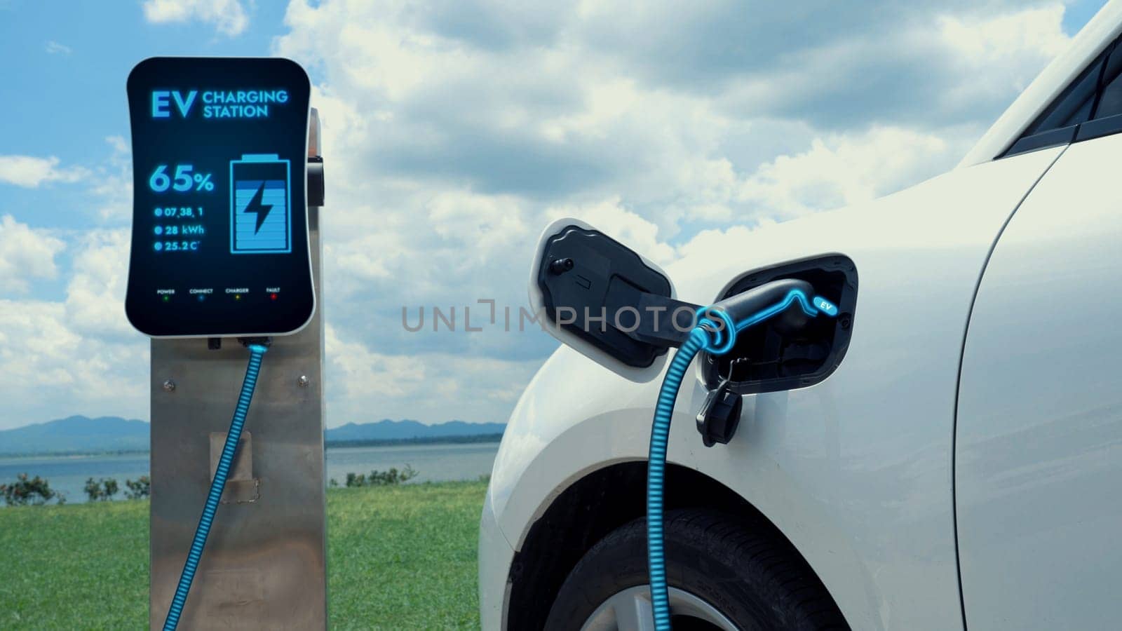 Electric car plugged in with charging station with nature background. Peruse by biancoblue