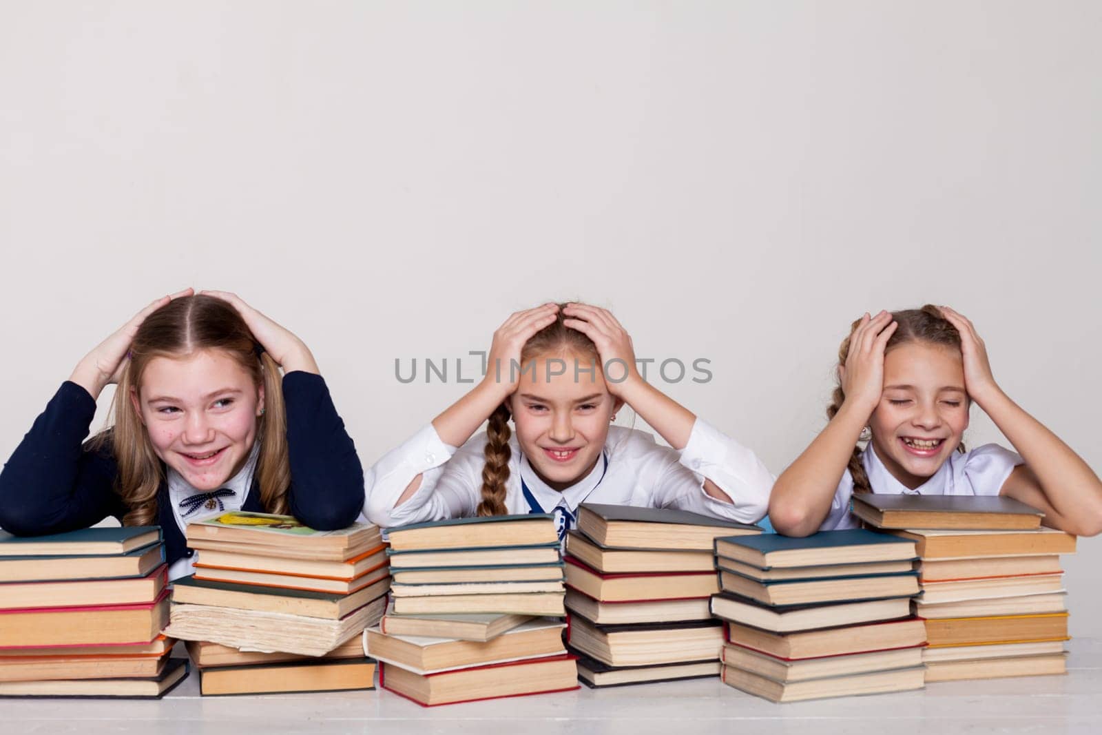 two girls with books in class at a desk at school