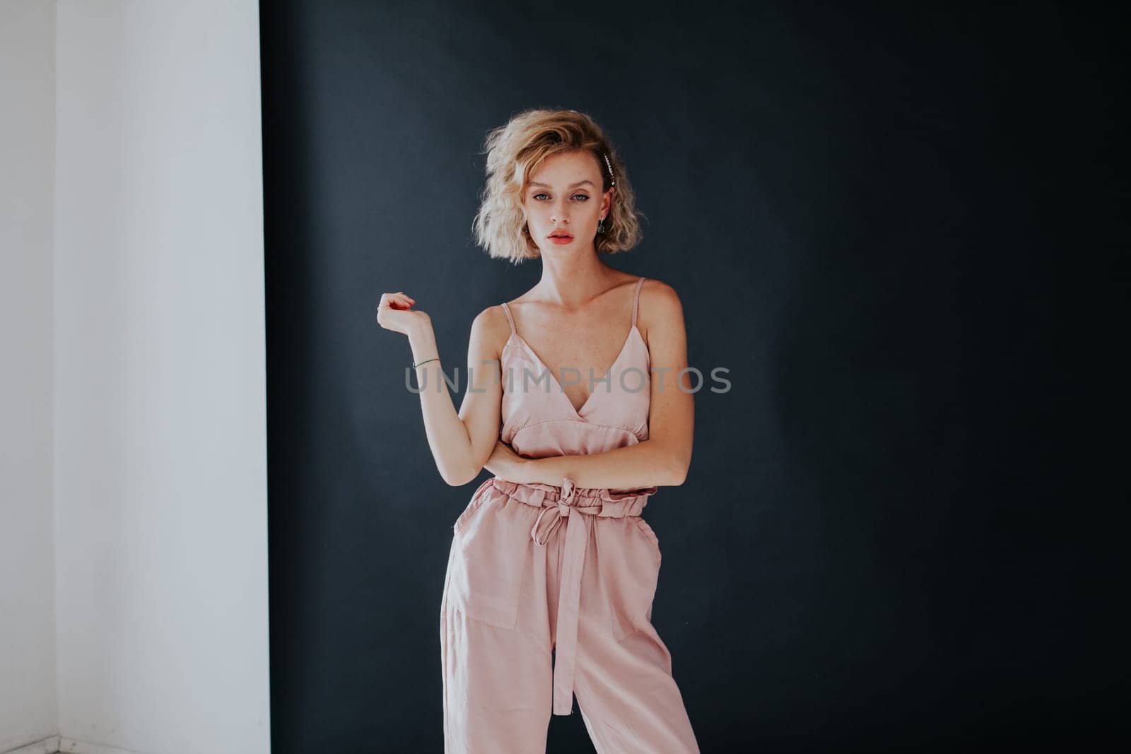 Portrait of a beautiful fashionable woman in a pink jumpsuit by Simakov