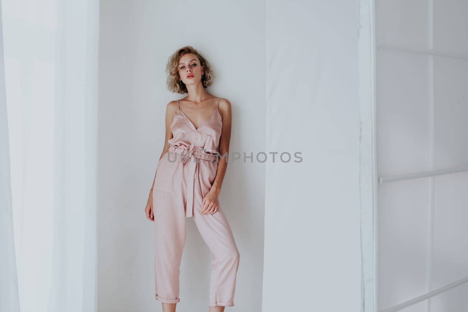 Portrait of a beautiful woman in a pink jumpsuit