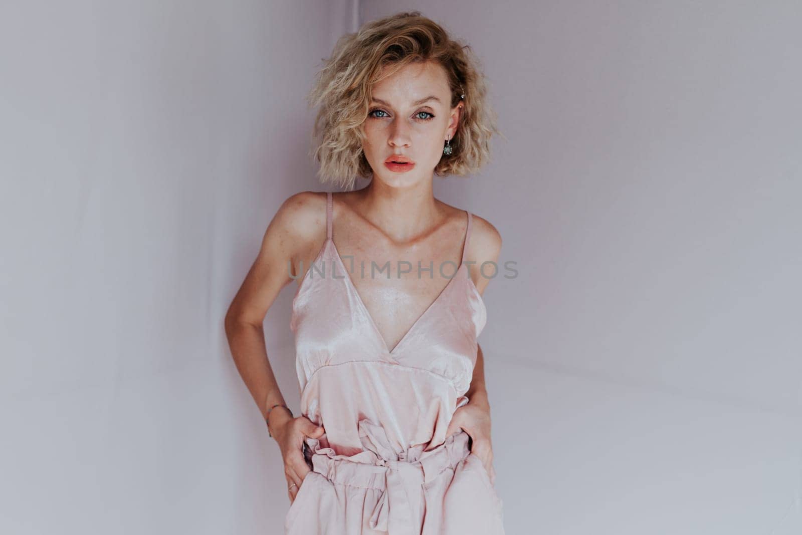 Portrait of a beautiful fashionable woman in a pink jumpsuit by Simakov