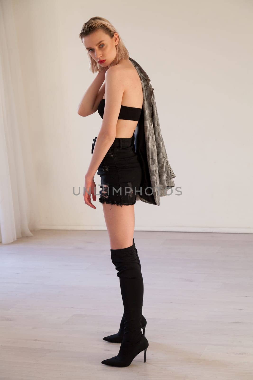 Porter beautiful blonde woman in clothes and boots