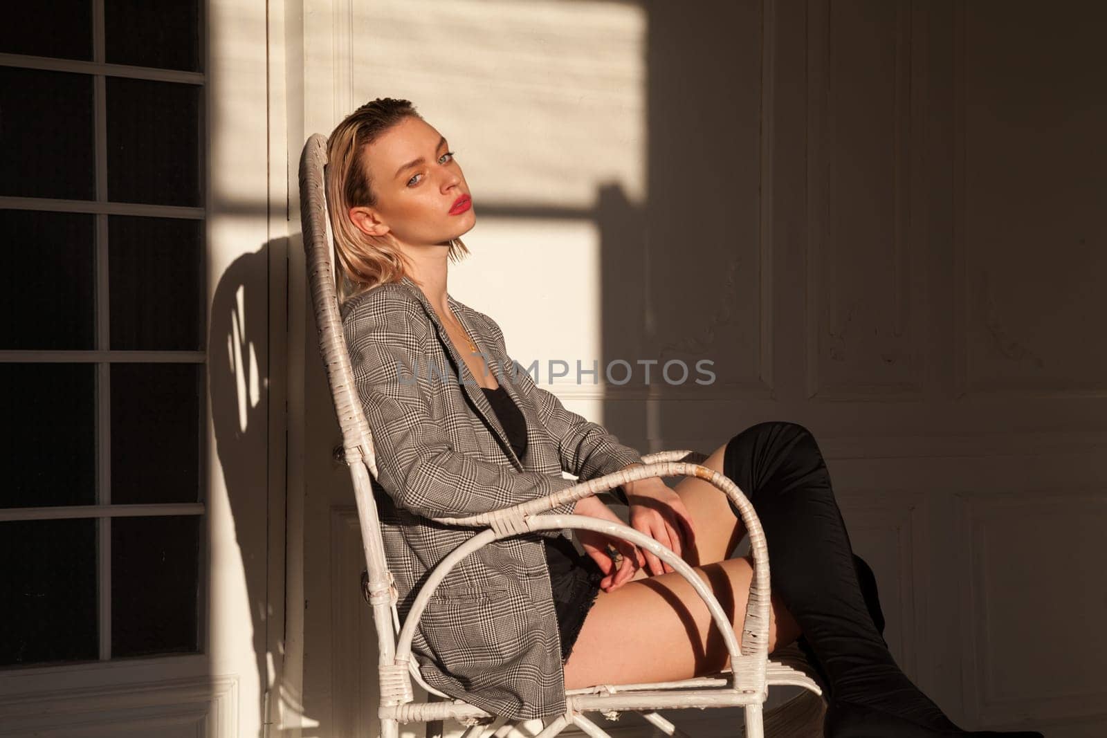 Porter beautiful fashionable blonde woman in clothes and boots by Simakov