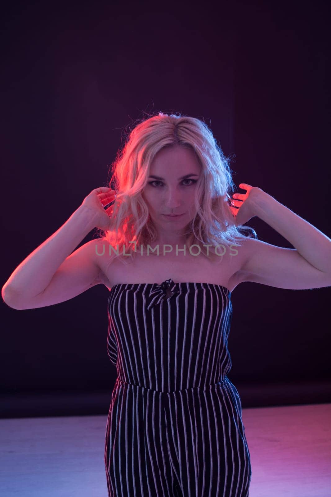 Portrait of a beautiful fashionable blonde woman in striped clothes by Simakov