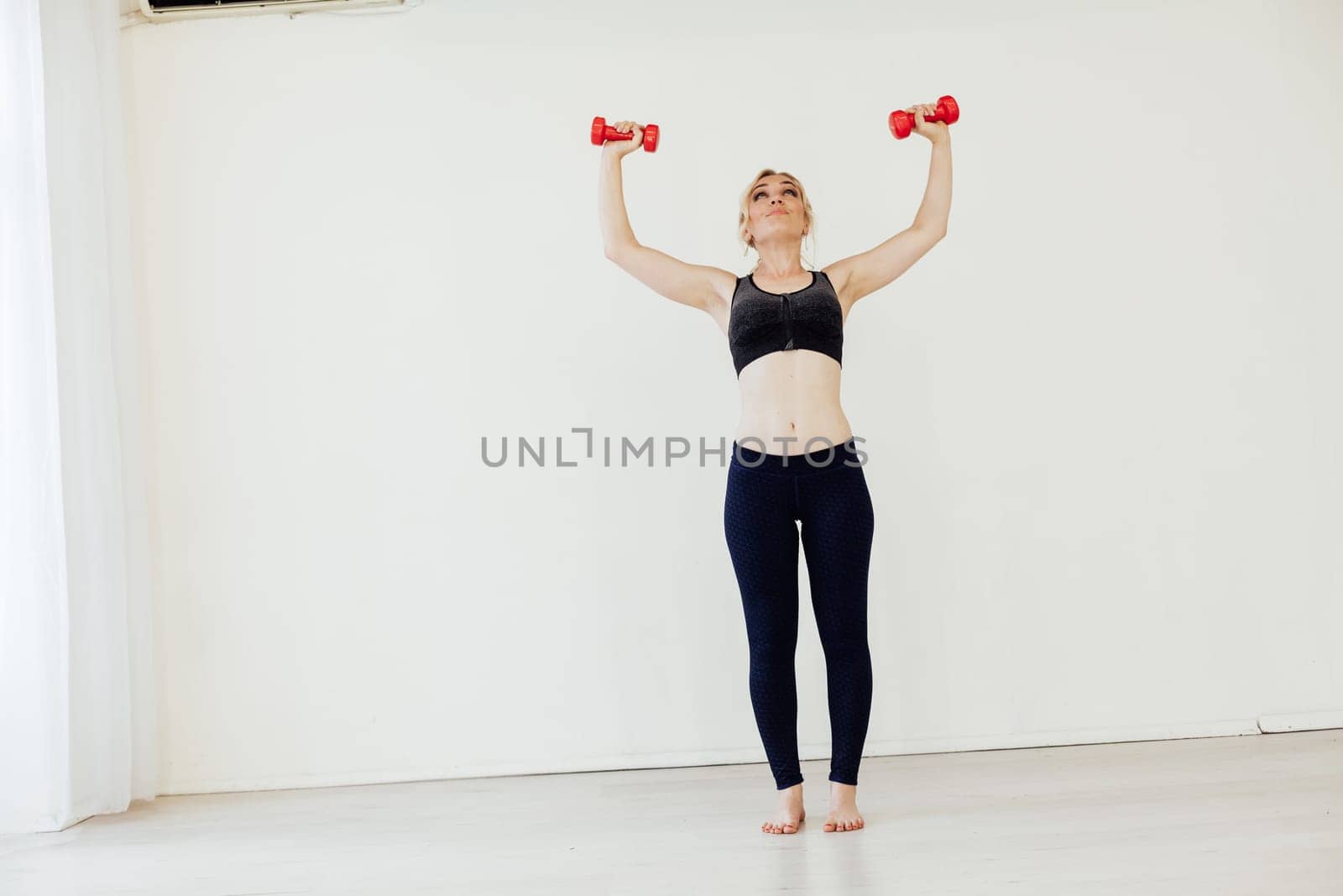 Blonde woman engaged in argument in the gym with fitness dumbbells