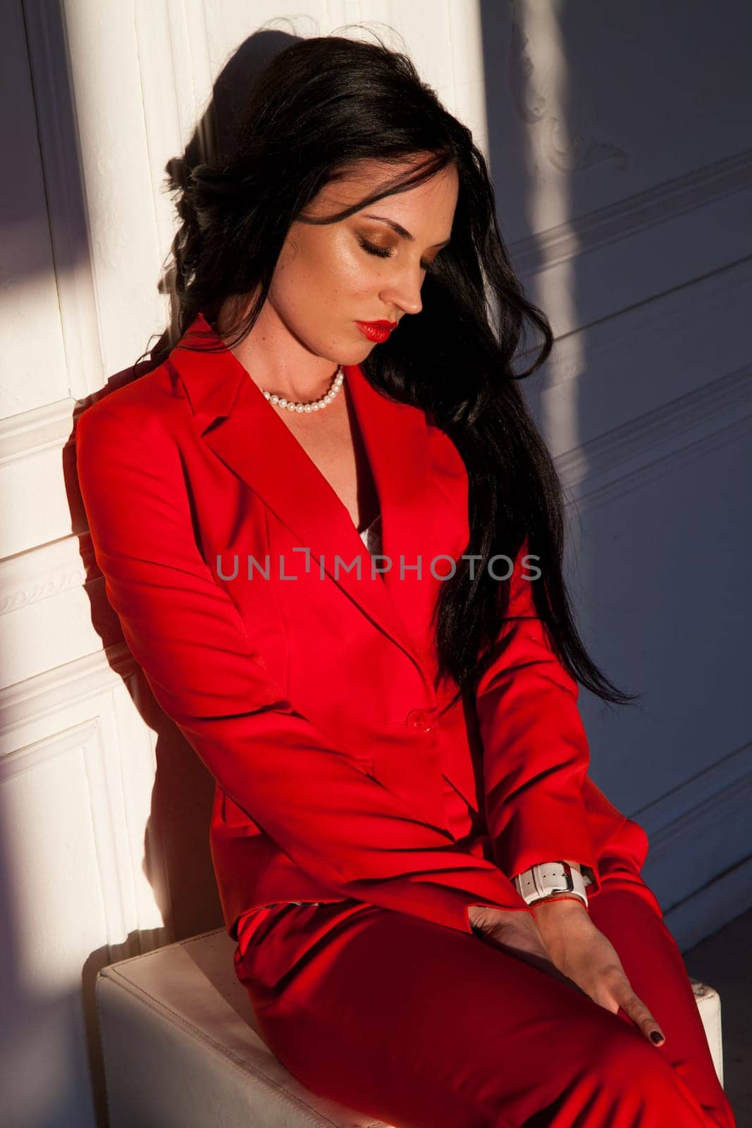 portrait of a beautiful woman in a red business suit in the office by Simakov