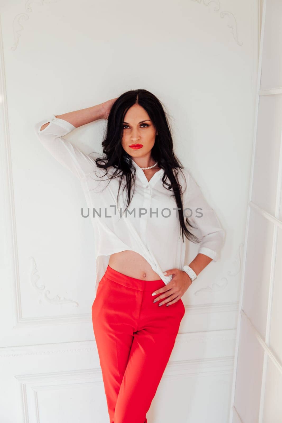 brunette woman stands by white background