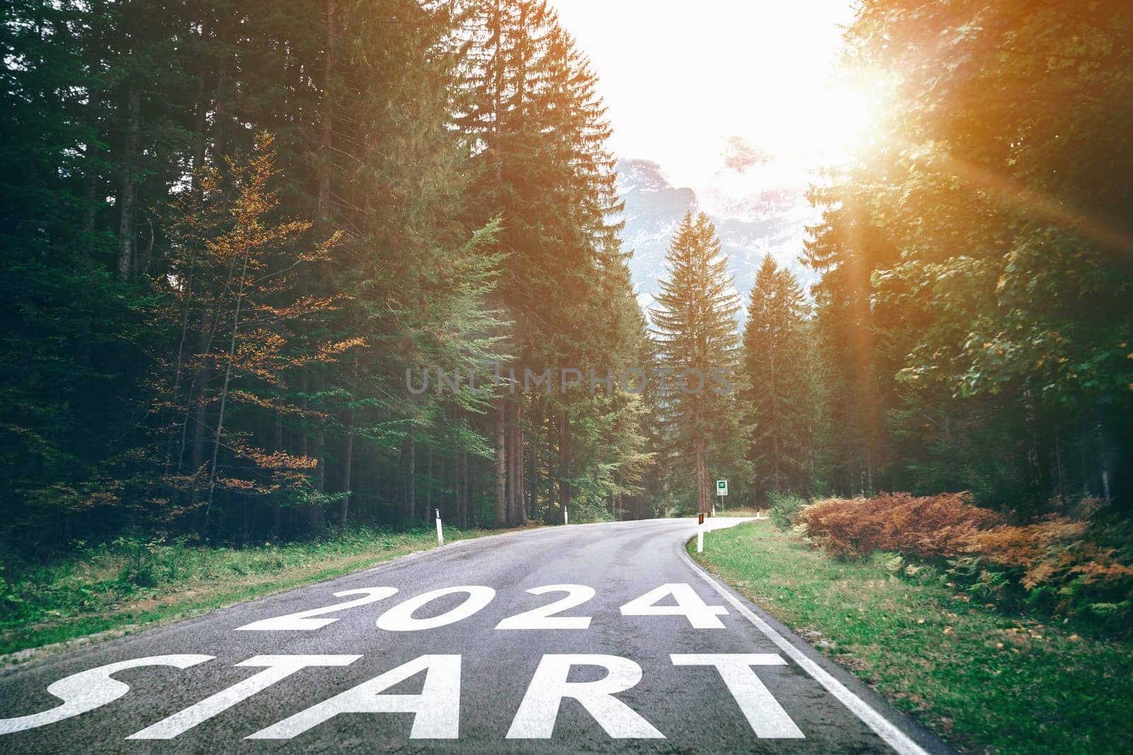 2024 New Year road trip travel and future vision concept . Nature landscape with highway road leading forward to happy new year celebration in the beginning of 2024 for bliss and successful start .