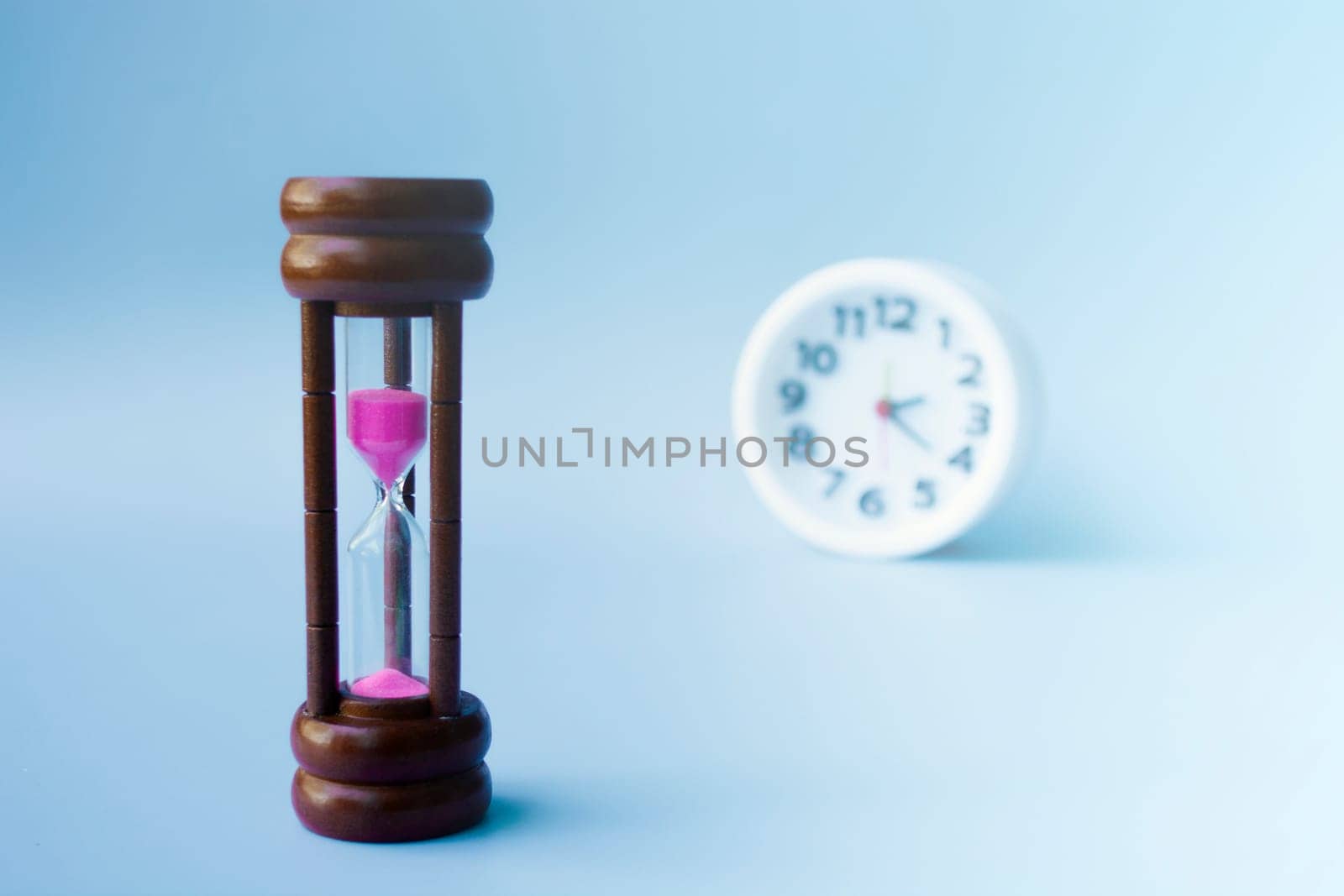 Hourglass as time passing concept for business deadline and running out of time