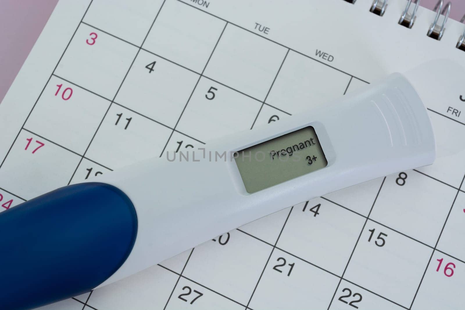 Positive pregnancy test on calendar. Trying To Conceive Concept.