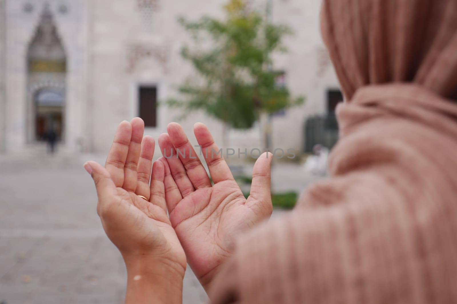 Muslim young woman in hijab is praying in mosque. by towfiq007