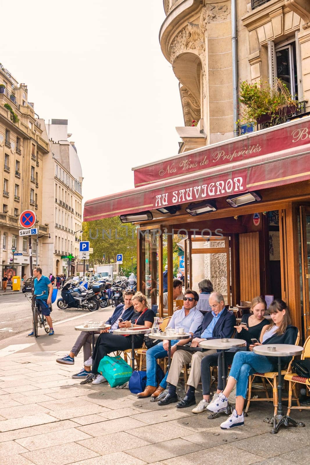 Paris France 20 September 2021, people drinking coffee on the terrace of a cafe restaurant during the Autumn end of summer.