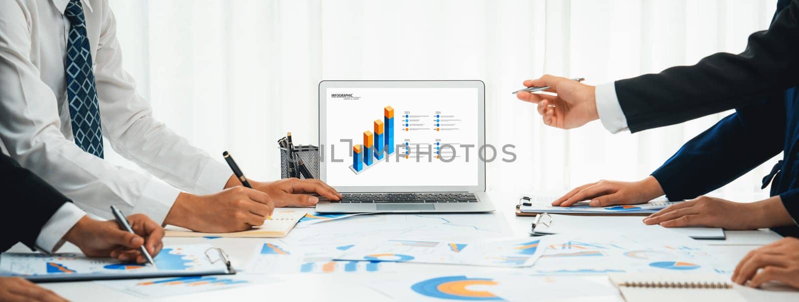 Business people in group meeting in formal attire share idea discussing report for company profit in creative workspace for start up business shot in close up view on group meeting table . Oratory .