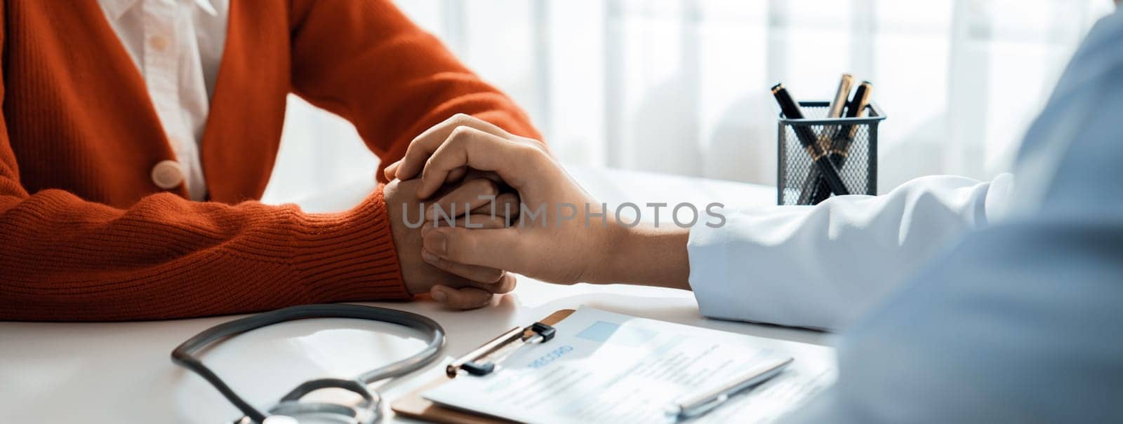 Patient attend doctor's appointment at clinic or hospital office, discussing medical treatment option and explaining diagnostic result while consoling and comforting patient. Panorama Rigid