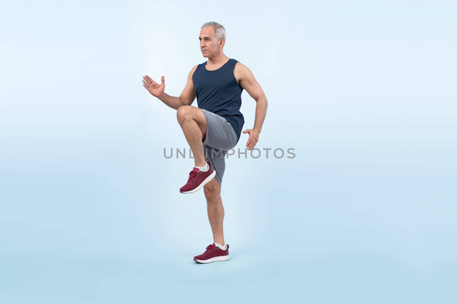 Active and fit senior man in sportswear portrait in running posture. Clout by biancoblue