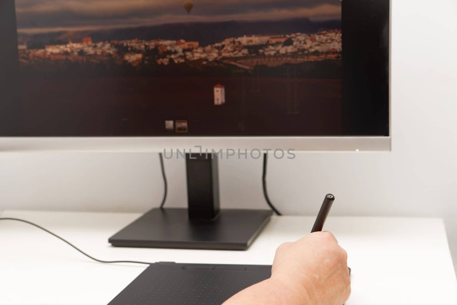 Woman hand working on her computer with a digital graphic tablet by joseantona