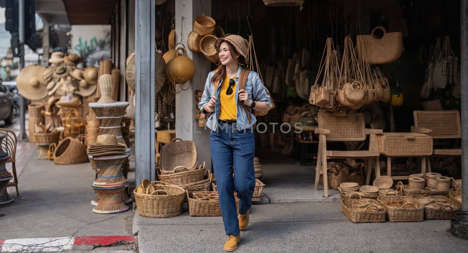 Young beautiful woman traveling at the local market during vacation. Tourist women travel enjoy shopping market during holidays, backpacker traveller.