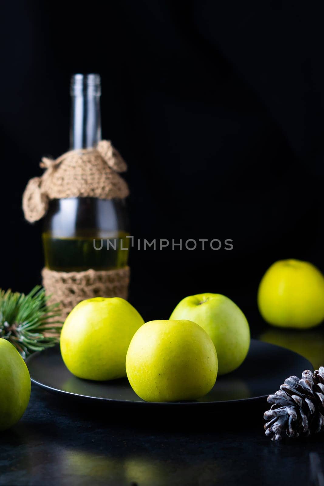 A ripe green apple fruits on dark stone table. Top view with copy space. Flat lay by Zelenin