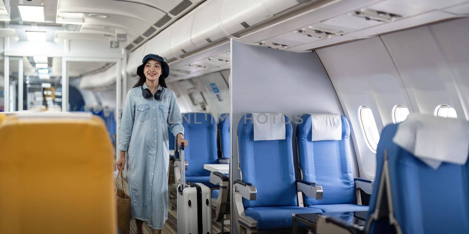 Young woman tourist with a suitcase at the airplane with a suitcase at the airplane.