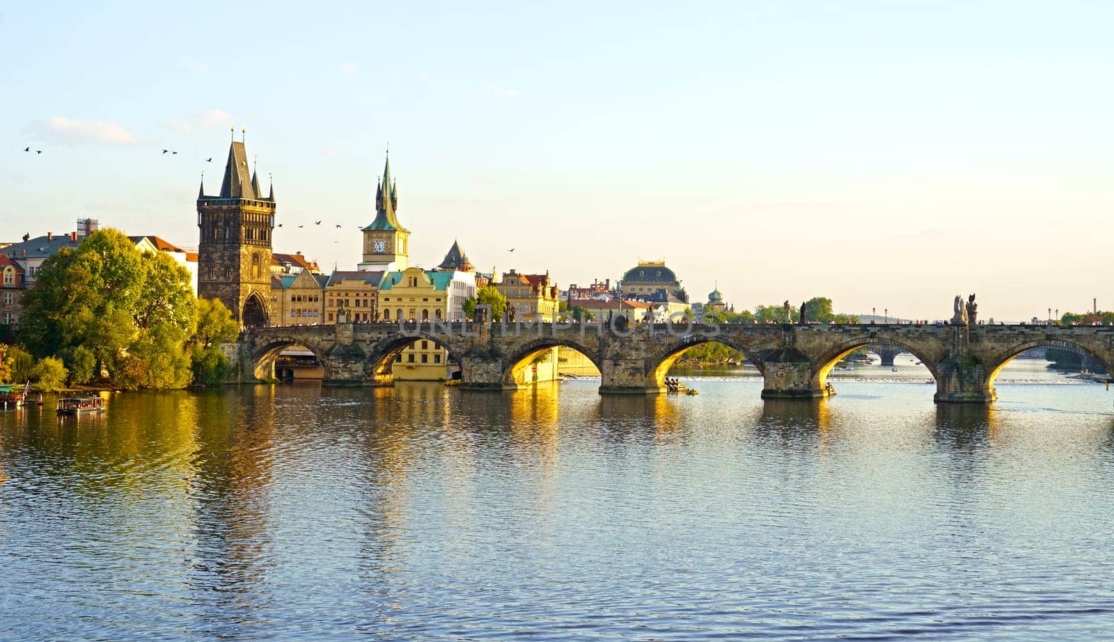 Prague - Charles bridge, Czech Republic. Scenic aerial sunset on the architecture of the Old Town Pier and Charles Bridge over the Vltava River in Prague, Czech Republic.