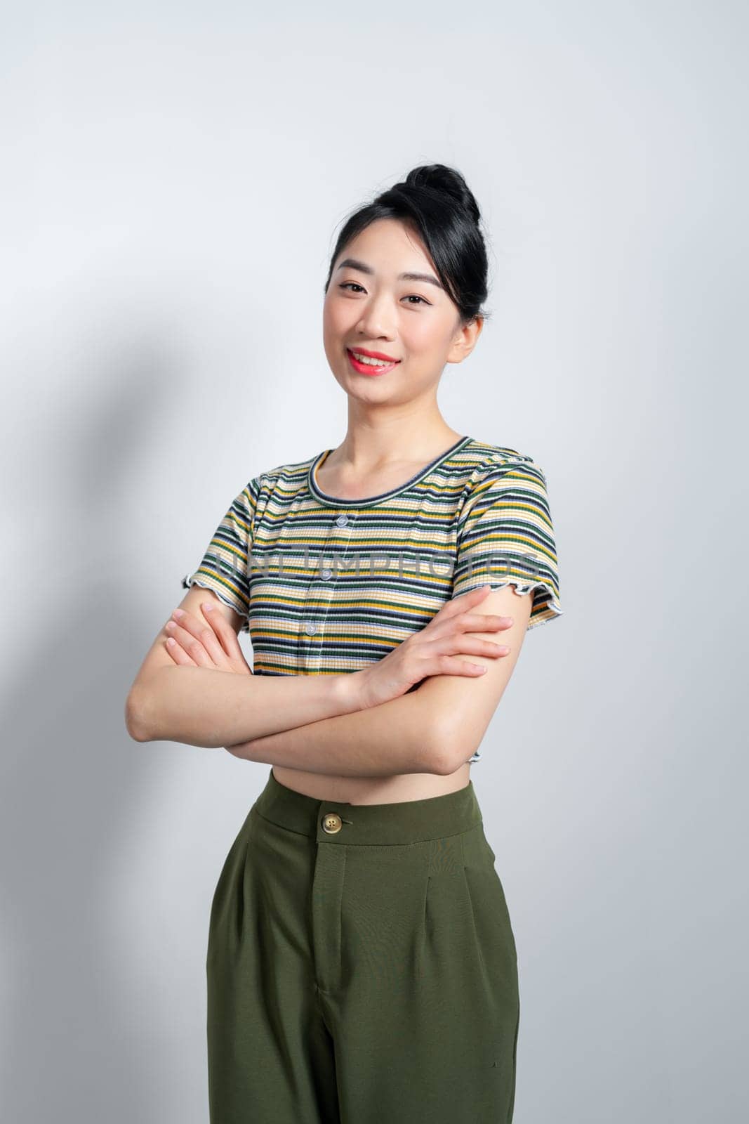 Portrait of Young beautiful Asian woman standing and smiling isolated on white background, Looking at camera