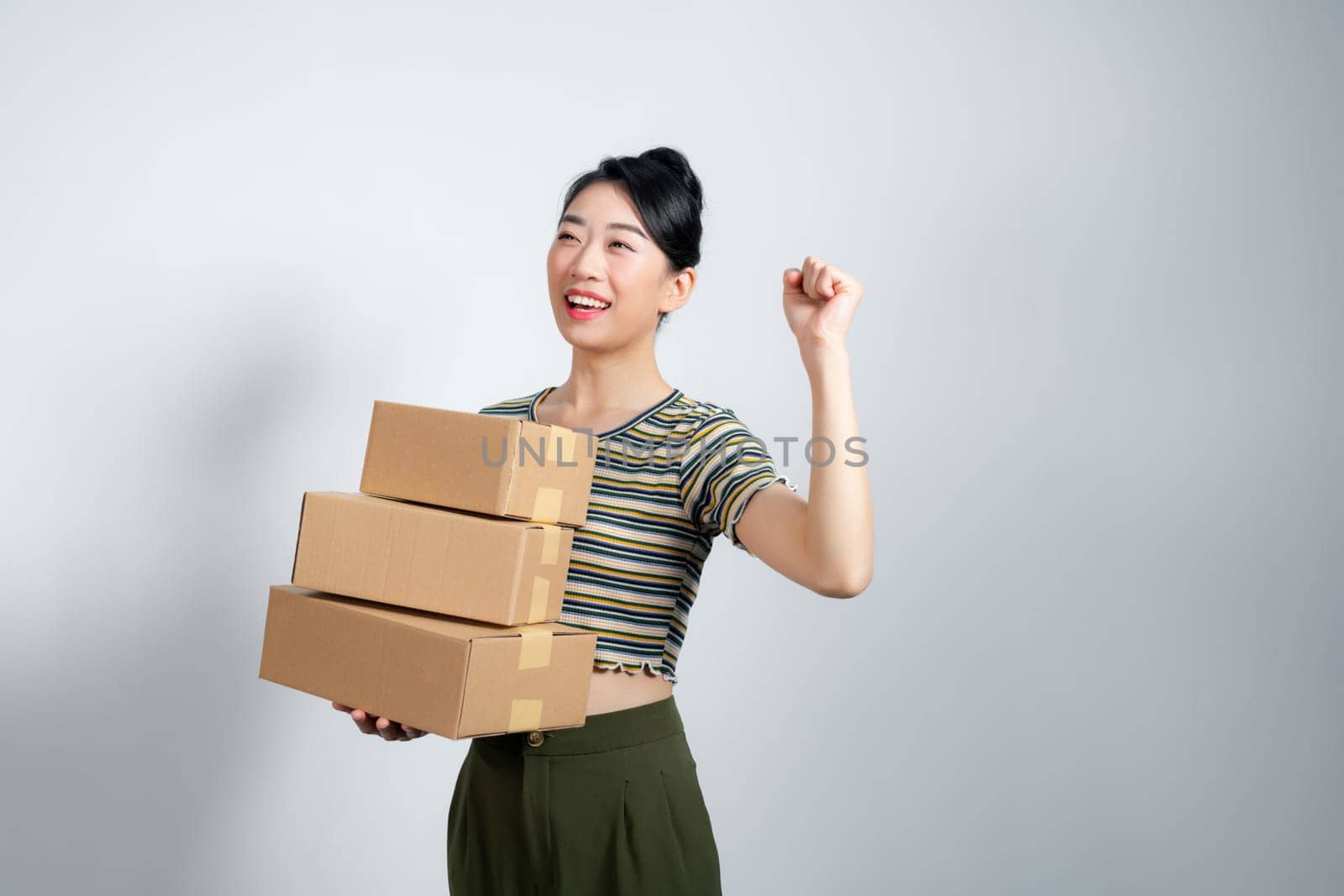 Young woman at online shop screaming proud, celebrating victory and success very excited with raised arms by makidotvn