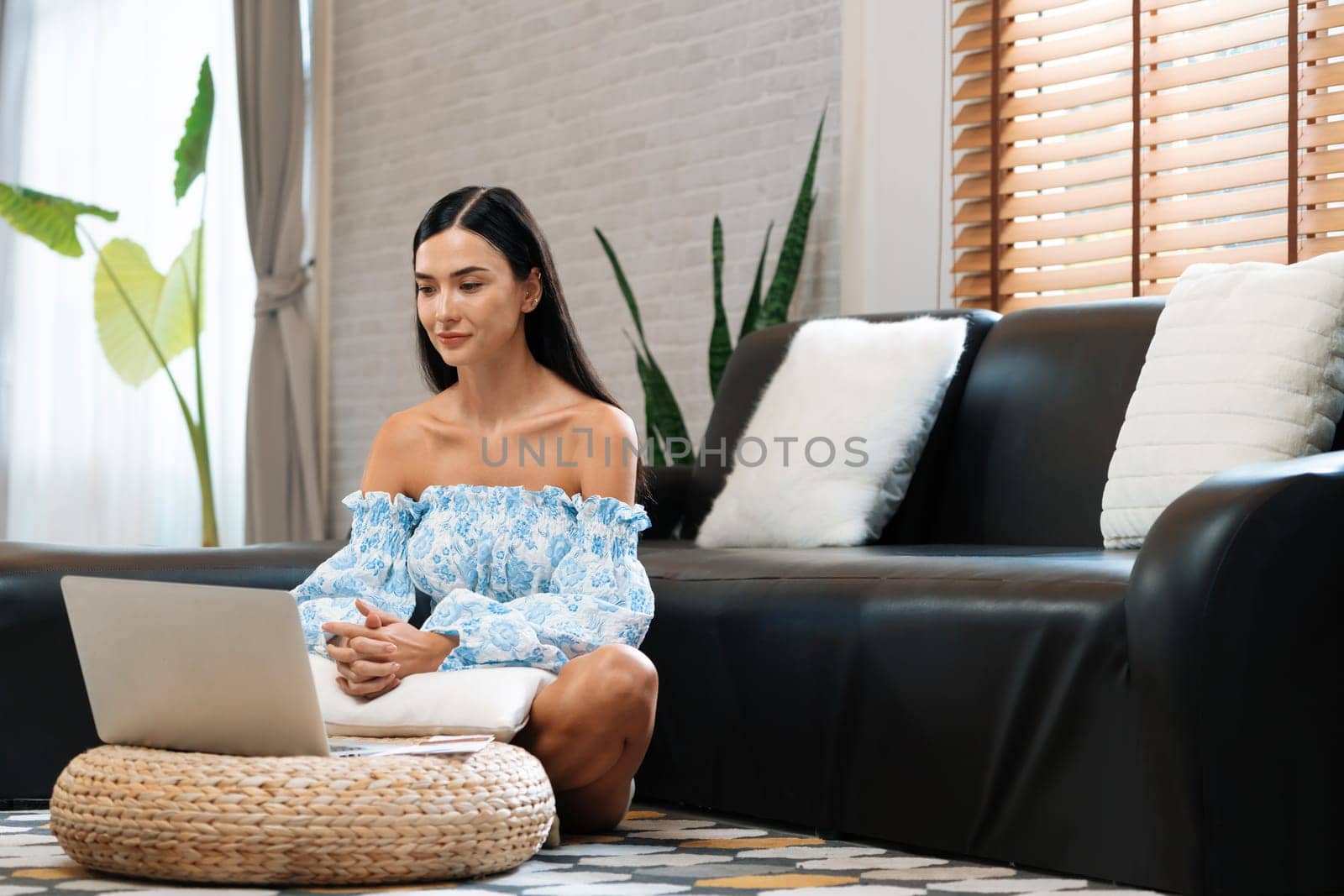 Young woman using laptop, happily browsing the internet at home. Blithe by biancoblue