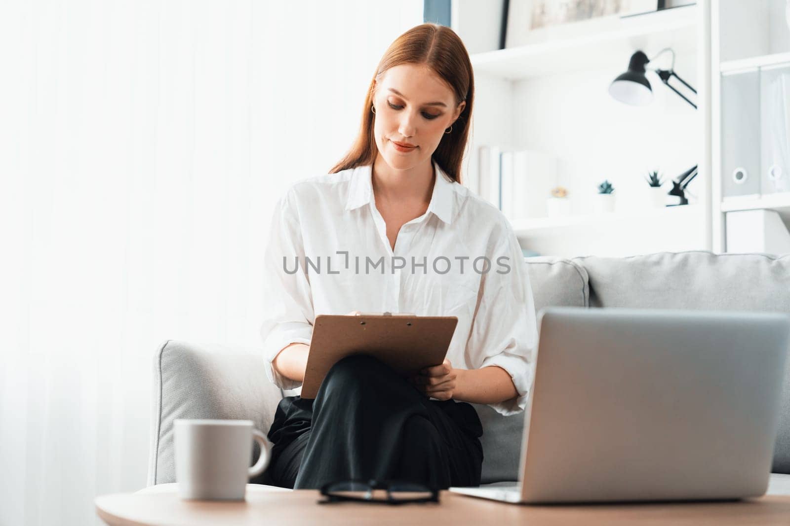 Psychologist woman in clinic office professional portrait with friendly smile feeling inviting for patient to visit the psychologist. The experienced and confident psychologist is utmost specialist