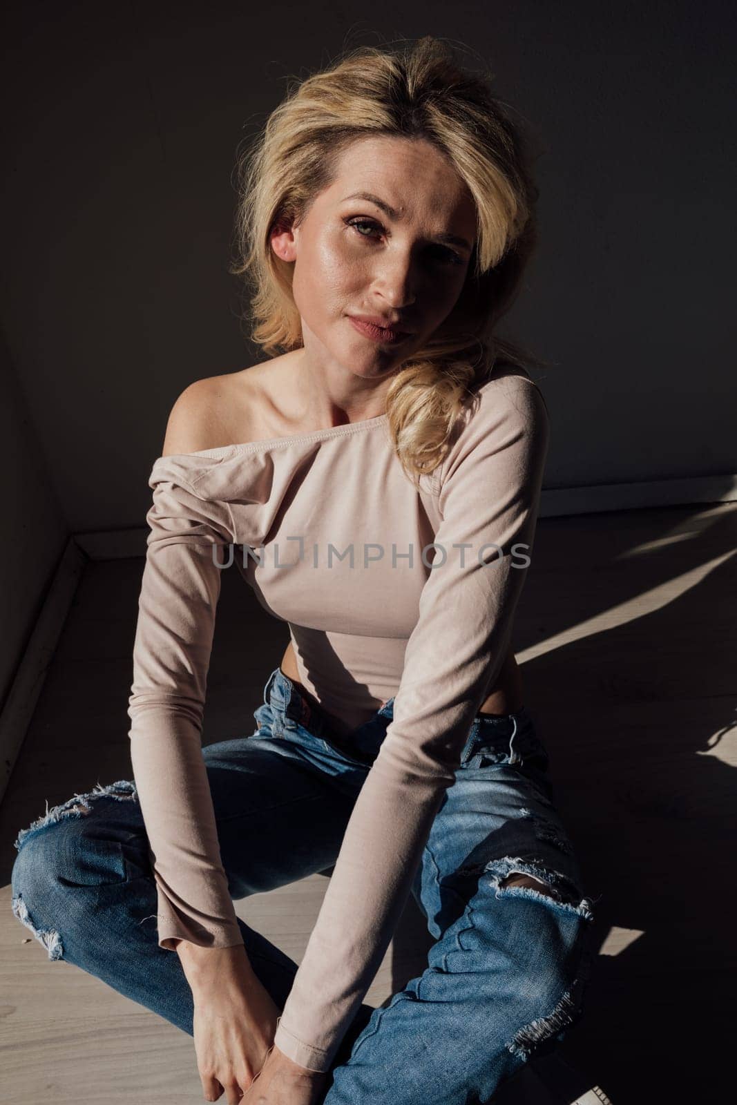 Beautiful blonde woman in jeans at home