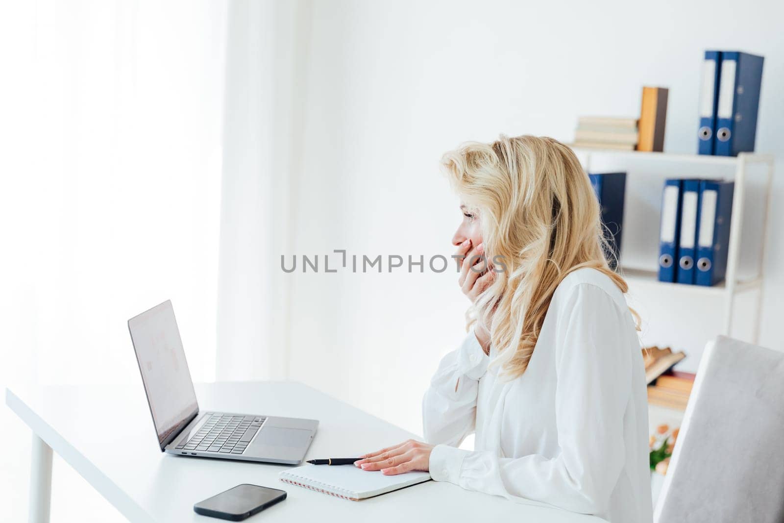 Business woman at computer in office at work by Simakov