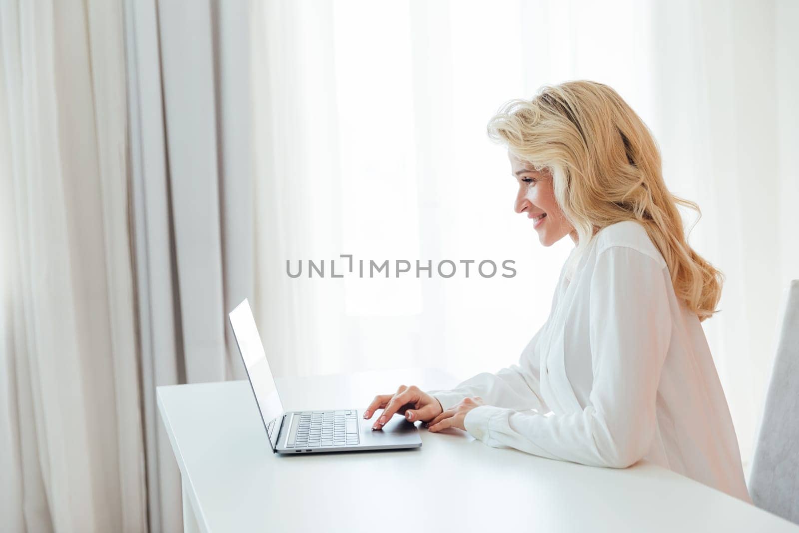 Business woman at computer in office at work by Simakov