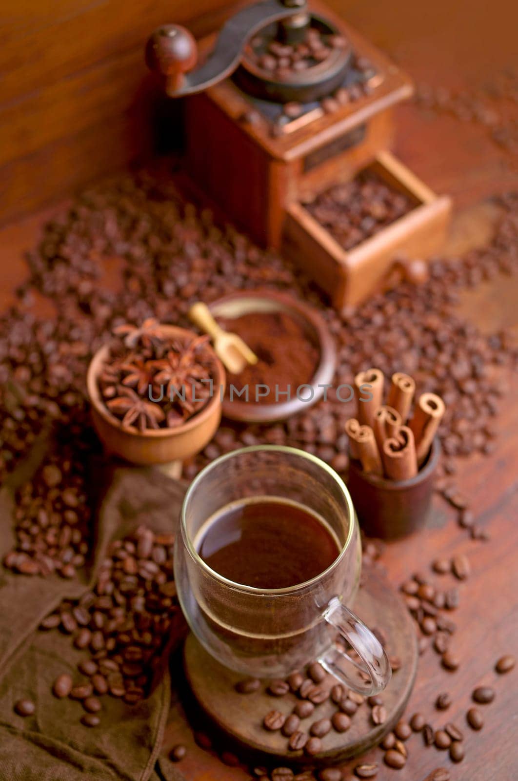 Tasty steaming espresso in cup with coffee beans. View from above. Dark background.