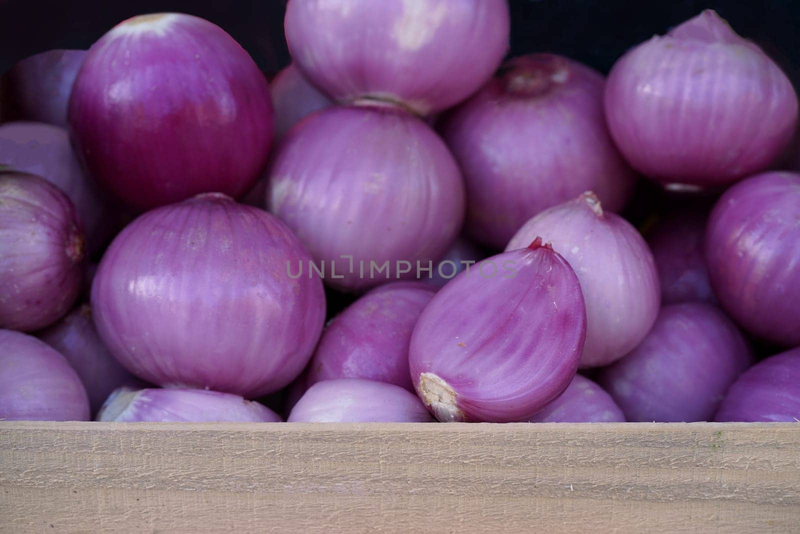 Red onions can be purchased at your local market. Fresh red onions sold in supermarket. Fresh raw food. by aprilphoto