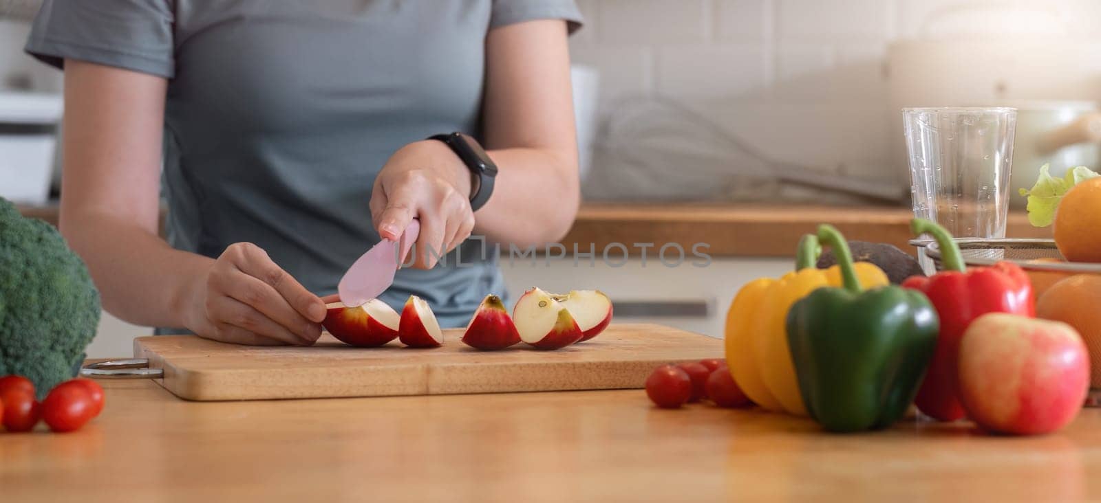 Healthy Asian woman takes care of her health by eating vegetable and fruit salad, adding vitamins in the kitchen. by wichayada