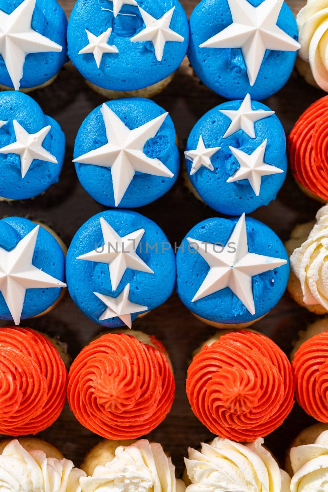 Arranging mini vanilla cupcakes in the shape of the American flag.