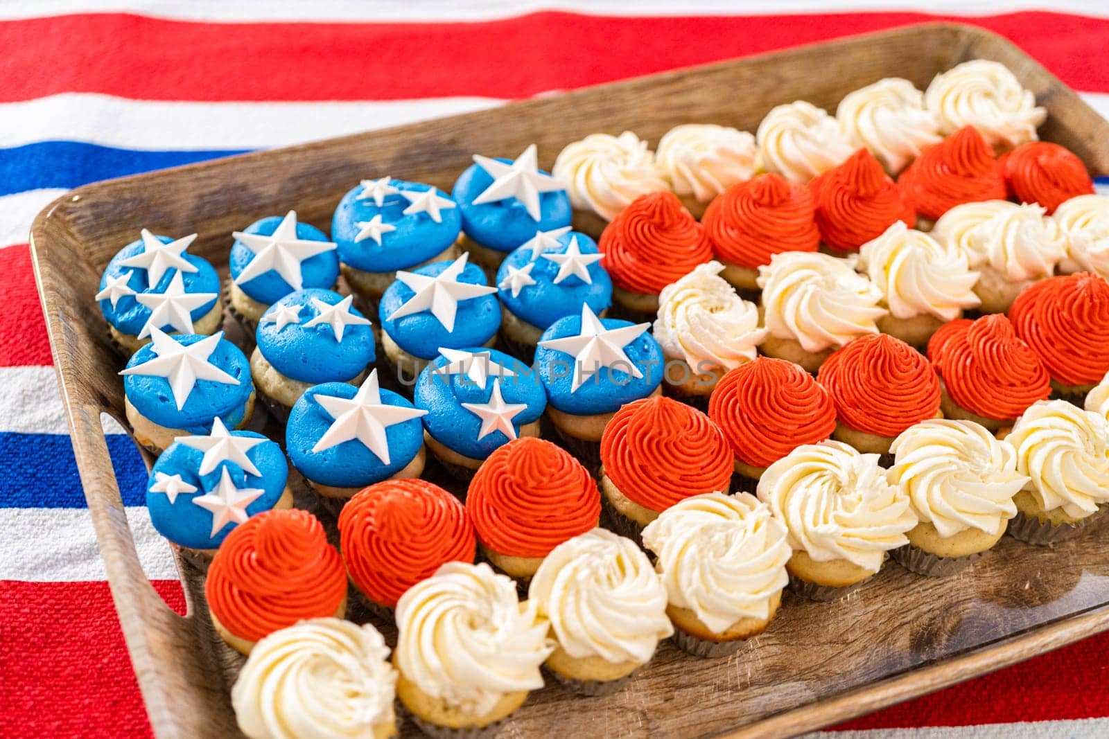 Arranging mini vanilla cupcakes in the shape of the American flag.