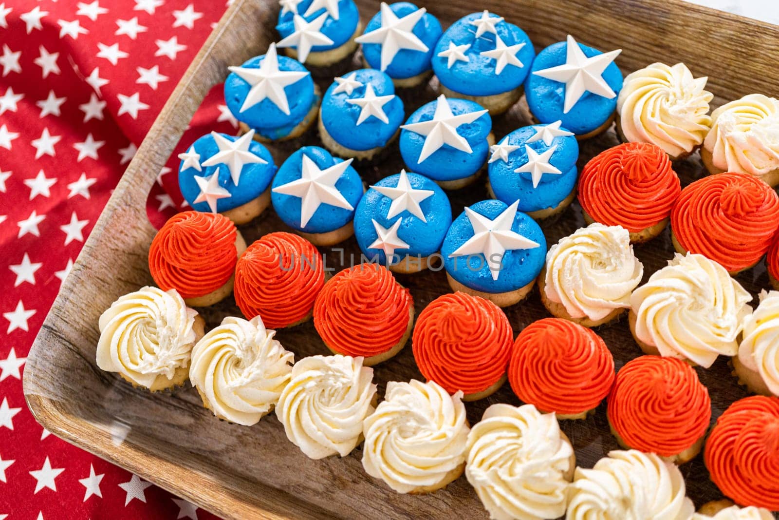 Arranging mini vanilla cupcakes in the shape of the American flag.