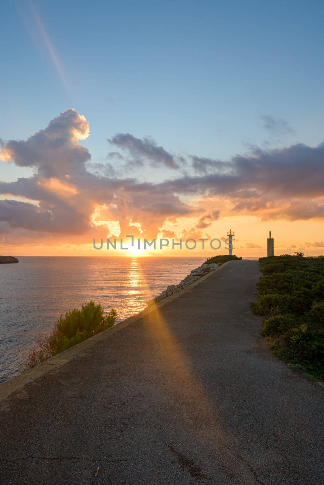 sunrise from the mediterranean sea in mallorca, on the way to the lighthouse by the cliffs,